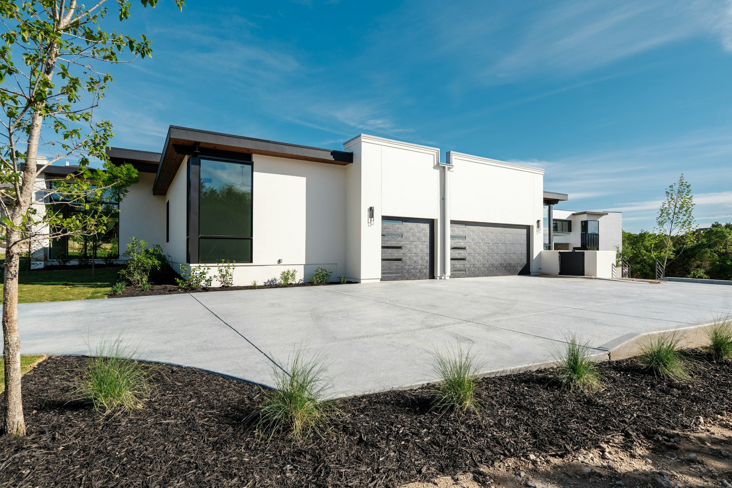 Modern home with a newly poured concrete driveway